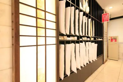 a store aisle with white towels on shelves at Smile Hotel Tokyo Ayase Ekimae in Tokyo