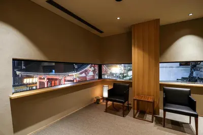 a waiting room with two chairs and two windows at Kaminarimon Ryokan in Tokyo