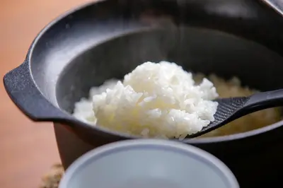 a pan full of rice being cooked at Kaminarimon Ryokan in Tokyo