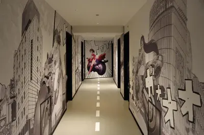 a hallway with art on the walls at EN Hotel Shibuya in Tokyo