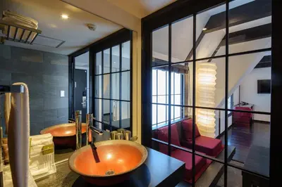 a bathroom with a sink and a tub in a room at EN Hotel Shibuya in Tokyo
