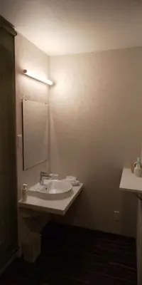 a bathroom with a sink and a mirror at Ueno First City Hotel in Tokyo