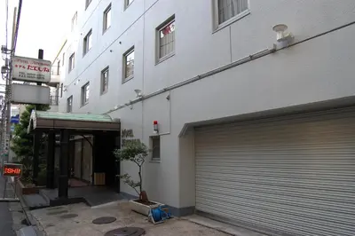 a building with a garage door on the side of it at Hotel Tateshina in Tokyo