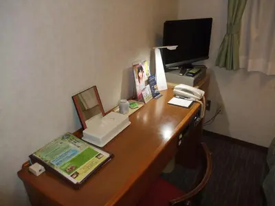 a desk with a phone and a computer on it at Hotel Tateshina in Tokyo