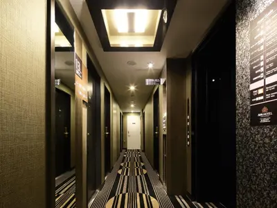 a long hallway with a bench in a building at APA Hotel Asakusa Kaminarimon in Tokyo