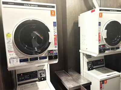 two washing machines are stacked on top of each other at APA Hotel Asakusa Kaminarimon in Tokyo