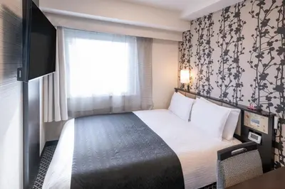 a hotel room with a bed and a window at APA Hotel Asakusa Kaminarimon in Tokyo