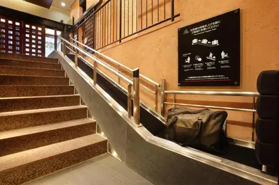 a set of stairs in a building with a bag at Hotel Nihonbashi Saibo in Tokyo