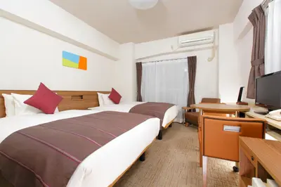 a hotel room with two beds and a television at HOTEL MYSTAYS Ueno Iriyaguchi in Tokyo