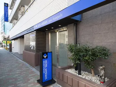 a building with a blue sign in front of it at HOTEL MYSTAYS Ueno Iriyaguchi in Tokyo