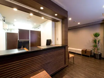 an office with a reception desk with a laptop on it at HOTEL MYSTAYS Ueno Iriyaguchi in Tokyo