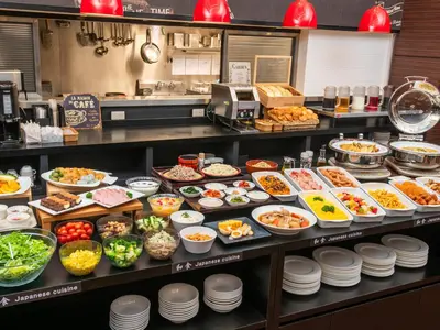 a buffet line with many different types of food at HOTEL MYSTAYS Ueno Iriyaguchi in Tokyo