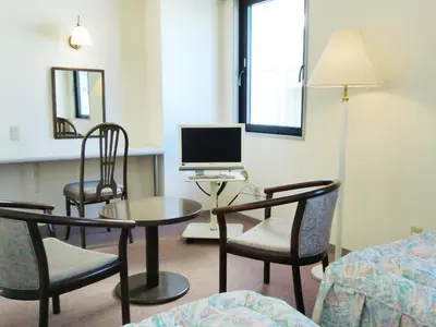 a room with chairs and a desk with a computer at Hotel Park Avenue in Tokyo