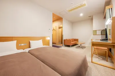 a hotel room with a bed and a television at Candeo Hotels Ueno Park in Tokyo
