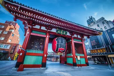a building with a sign on the side of a street at Candeo Hotels Ueno Park in Tokyo