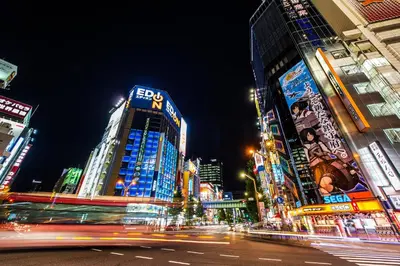 a busy city street at night with tall buildings at Candeo Hotels Ueno Park in Tokyo