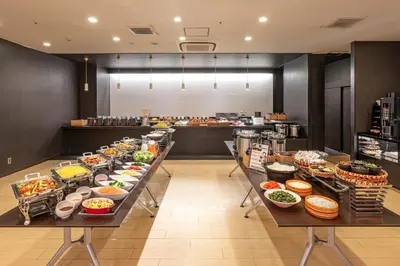 a buffet line with many different types of food at Candeo Hotels Ueno Park in Tokyo