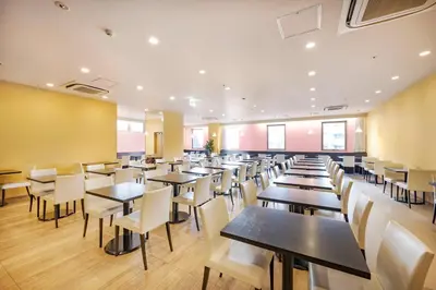 a dining room with tables and chairs at Candeo Hotels Ueno Park in Tokyo