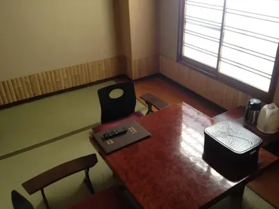 a room with a table and chairs and a window at Hotel Edoya in Tokyo