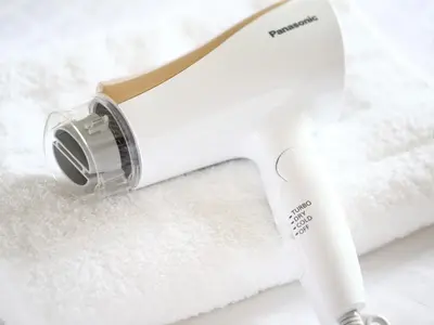 a white blow dryer sitting on top of white towels at KOKO HOTEL Ueno Station - formerly Hotel Wing International Select Ueno Okachimachi in Tokyo