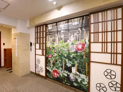 a mural of flowers on a wall in a hallway at KOKO HOTEL Ueno Station - formerly Hotel Wing International Select Ueno Okachimachi in Tokyo