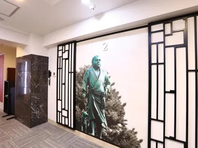 a door with a picture of a statue on it at KOKO HOTEL Ueno Station - formerly Hotel Wing International Select Ueno Okachimachi in Tokyo
