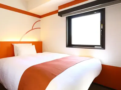 a bedroom with a bed and a window at KOKO HOTEL Ueno Station - formerly Hotel Wing International Select Ueno Okachimachi in Tokyo