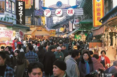 a crowd of people walking down a busy street in a city at Sky Heart Hotel Koiwa in Tokyo