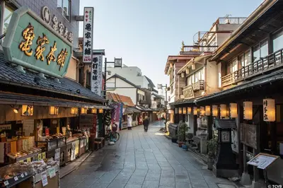 a street in an asian city with shops and buildings at Sky Heart Hotel Koiwa in Tokyo