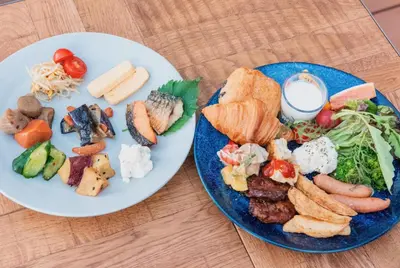 two plates of food on a wooden table at HOTEL HILLARYS Akasaka in Tokyo