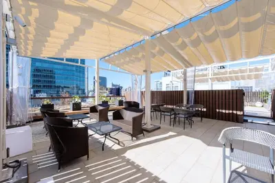 a patio with tables and chairs on a building at HOTEL HILLARYS Akasaka in Tokyo