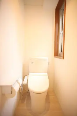 a bathroom with a white toilet in a room at Base Inn Tabata in Tokyo