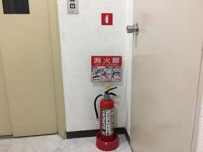 a fire hydrant in the corner of a room at Base Inn Tabata in Tokyo