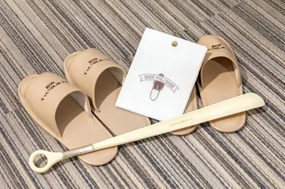 a pair of sandals with a book and a wand at Ginza Capital Hotel Akane in Tokyo
