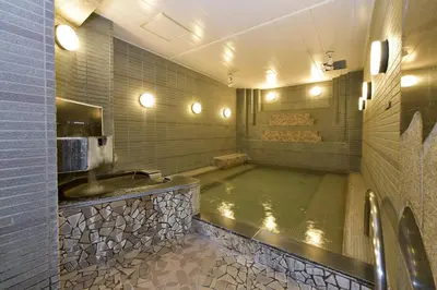 a bathroom with a large tub with a sink at Refre Forum in Tokyo