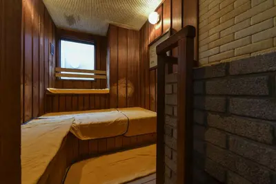 a room with two beds and a brick wall at Refre Forum in Tokyo