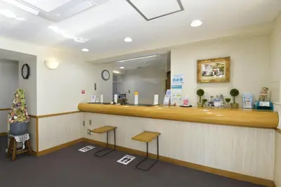 a restaurant with a counter with two stools at Refre Forum in Tokyo