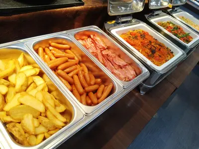 a buffet line with trays of food and french fries at Hotel Grand City in Tokyo