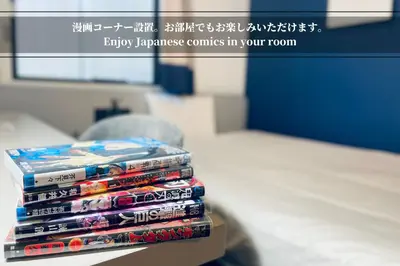 a stack of japanese anime books sitting on a table at Henn na Hotel Tokyo Ginza in Tokyo