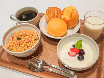 a tray with three bowls of breakfast foods and drinks at Henn na Hotel Tokyo Ginza in Tokyo