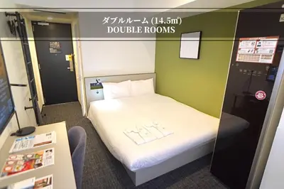 a small room with a white bed and green walls at Henn na Hotel Tokyo Ginza in Tokyo