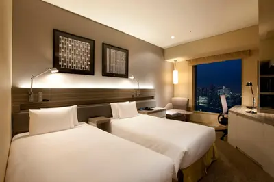 a hotel room with two beds and a window at The Royal Park Hotel Iconic Tokyo Shiodome in Tokyo