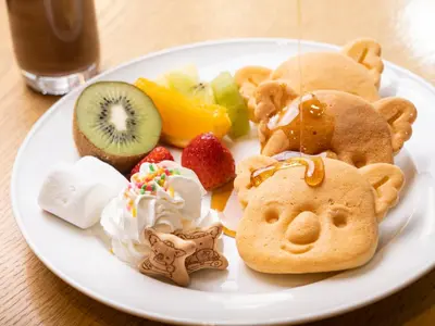 a plate of food with cookies and fruit on a table at Lotte City Hotel Kinshicho in Tokyo