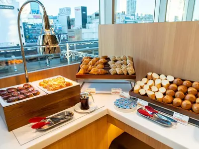 a bakery with many different types of donuts on a counter at Lotte City Hotel Kinshicho in Tokyo