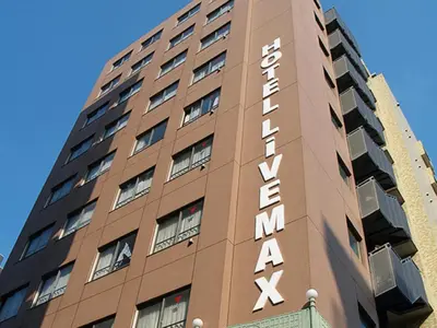 a tall brown building with a sign on it at HOTEL LiVEMAX BUDGET Higashi Ueno in Tokyo