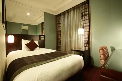 a bedroom with a large bed and a window at Hotel Trusty Tokyo Bayside in Tokyo