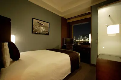 a hotel room with a bed and a window at Hotel Trusty Tokyo Bayside in Tokyo