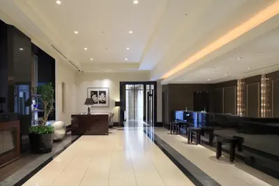 a lobby with tables and chairs in a building at Hotel Trusty Tokyo Bayside in Tokyo