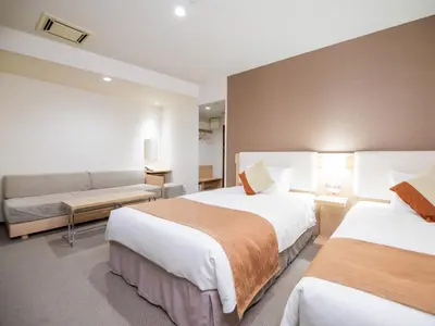 a hotel room with two beds and a couch at Tokyu Stay Nihonbashi in Tokyo