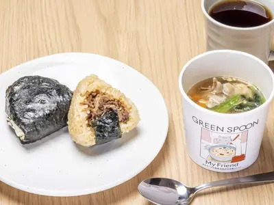 a white plate with a doughnut and a cup of coffee at Tokyu Stay Nihonbashi in Tokyo
